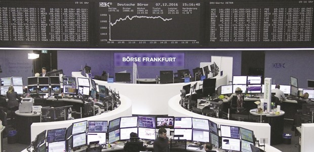 Traders work at the Frankfurt Stock Exchange. The DAX 30 rose 2% to 10,986.69 yesterday.