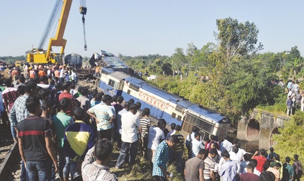 Villagers gather where the Capital Express train derailed at Samuktala Road station in the Alipurduar district of West Bengal yesterday.