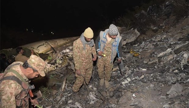Pakistani soldiers search for victims from the wreckage of the crashed PIA passenger plane Flight PK661 in the village of Saddha Batolni in the Abbottabad district of Khyber Pakhtunkhwa province on Wednesday.