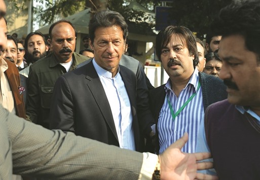 Pakistani cricketer-turned-opposition leader and head of Pakistan Tehreek-i-Insaf (PTI), Imran Khan (CL) leaves the Supreme Court after attending a hearing on the Panama Papers in Islamabad yesterday. A Pakistani opposition party abruptly called off a planned u201clockdownu201d of the capital after the Supreme Court paved the way for an investigation into allegations of corruption against the prime ministeru2019s family