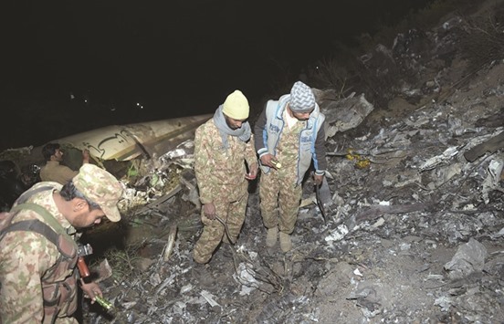 Pakistani soldiers search for victims from the wreckage of the crashed PIA passenger plane Flight PK661 at the site in the village of Saddha Batolni in the Abbottabad district of Khyber Pakhtunkhwa province yesterday.
