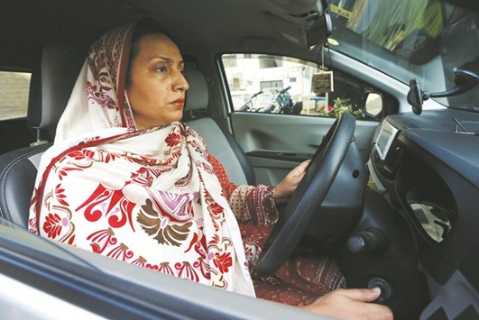 Aasia Abdul Aziz, one of the pioneer women drivers of Careem, drives her car in Karach yesterday.