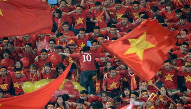 Vietnamese fans shout before the start of the Suzuki Cup semi-final second leg match between Vietnam and Indonesia