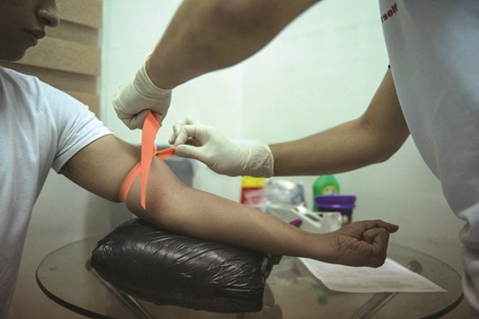 A nurse extracts blood from an individual undergoing HIV testing at the LoveYourself Anglo Centre in Manila. HIV infections among men having sex with men in the Philippines have surged 10-fold in five years, with authorities largely ignoring the problem, Human Rights Watch said in a report released yesterday.