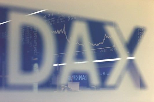 The German share price index DAX board is reflected in a glass at the stock exchange in Frankfurt yesterday. The benchmark DAX 30 rose 1.3% at 11,179.42 for the day.