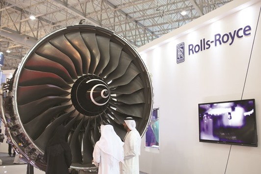 Visitors inspect a Trent 900 jet engine displayed at the Rolls-Royce Holdings exhibition stand at the 14th Dubai Air Show. Emirates, the biggest operator of the A380, is due to take receipt of 50 of the Airbus planes equipped with Rolls-Royce engines after switching from the competing GP7000 turbine manufactured by an alliance of General Electric Co and Pratt & Whitney, which powered its first 90 aircraft.
