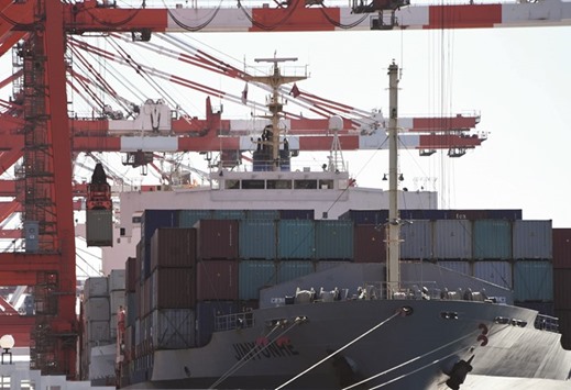 A container is loaded onto a freighter at the container yard in Tokyo port. Japanu2019s third-quarter GDP was weaker than thought with a 0.3% expansion, revised data showed yesterday, as slack corporate spending held back the worldu2019s number three economy.