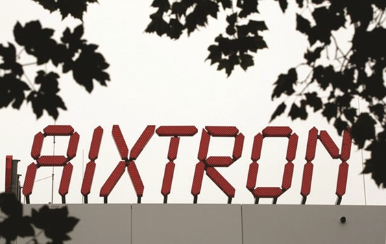 The logo of Aixtron is seen on the roof of the German chip equipment makeru2019s headquarters in Herzogenrath near the western German city of Aachen. The Chinese  government-backed Grand Chip Investment said its offer could no longer be fulfilled after Washington rejected the inclusion of Aixtronu2019s US unit over fears it could put  sensitive technology with potential military applications in Chinese hands.