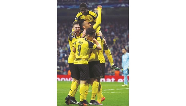 Borussia Dortmundu2019s players celebrate after Marco Reus scored the equaliser against Real Madrid in the Champions League match in Madrid on Wednesday. (AFP)