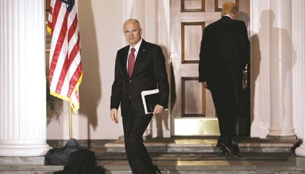 This November 19 picture shows Puzder leaving after meeting President-elect Trump (right) at the main clubhouse at Trump National Golf Club in Bedminster, New Jersey.