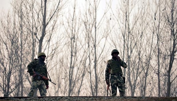 Indian paramilitary troopers stand guard near the site of a gunbattle between suspected militants and security personnel at Arwani Bijbehara, south of Srinagar, on Thursday.