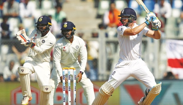 Englandu2019s Jos Buttler belts the ball at the Wankhede Stadium in Mumbai on the way to his 76 against India.