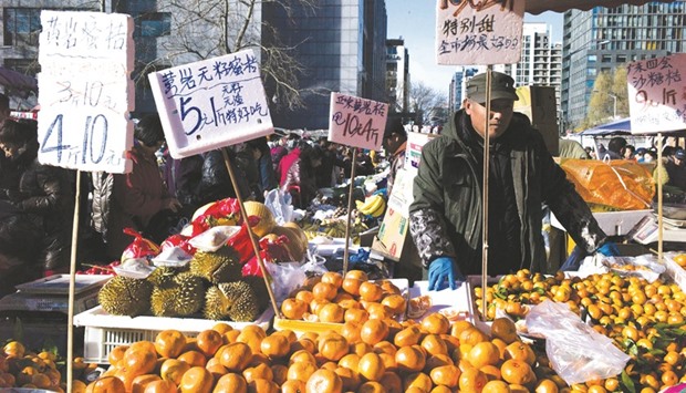 A vendor waits for customers at a market in Beijing. Chinau2019s consumer price index, a key gauge of retail inflation, rose 2.3% in November, slightly beating expectations of 2.2%, according to figures released yesterday.