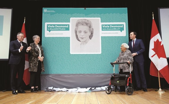 Canadau2019s Finance Minister Bill Morneau with Wanda Robson after her sister Viola Desmond was chosen to be featured on a new $10 banknote during a ceremony at the Museum of History in Gatineau, Quebec. With them are Bank of Canada governor Stephen Poloz and Minister of Status of Women Patty Hajdu.