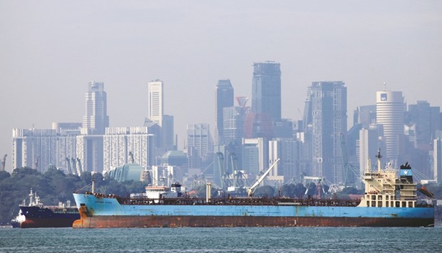 Oil tankers pass the skyline of Singapore. Sources at eight refiners in Asia told Reuters they had been notified by oil giant Saudi Aramco that in January it was set to supply full amounts of crude contracted as part of annual deals.
