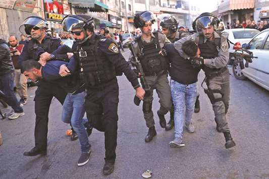 Israeli security forces detain Palestinian protesters, in East Jerusalem.