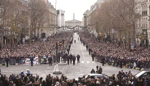 Mourners are seen in front of Parisu2019s La Madeleine church prior to the funeral ceremony for late French singer Johnny Hallyday, yesterday.