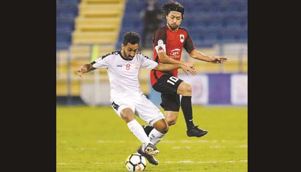 Umm Salalu2019s Adel al-Yafi (left) and Al Rayyanu2019s Rodrigo Tabata in action during the QNB Stars League match yesterday. PICTURE: Shemeer Rasheed