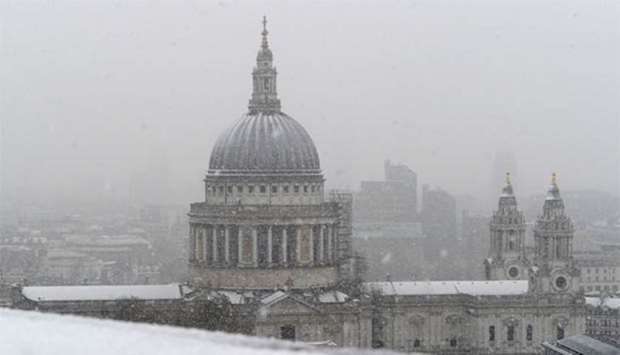 St Paul's Cathedral is seen as snow falls over central London on Sunday.