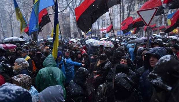 Supporters wave flags as they attend a rally in support of arrested former Georgian president Mikheil Saakashvili outside a detention centre in Kiev on Sunday.