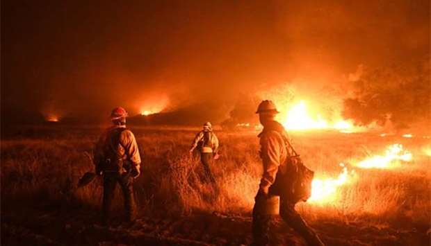 Firefighters light backfires as they try to contain the Thomas wildfire which continues to burn in Ojai, California.