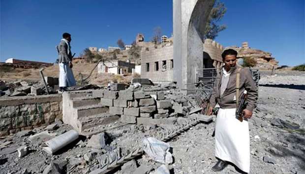 Yemenis look at the damage in the aftermath of an air strike by the Saudi-led coalition on the Houthi rebel-controlled state TV station in Sanaa on Sautrday.