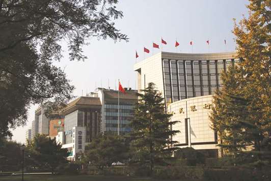 The Peopleu2019s Bank of China headquarters (right) in Beijing. The PBoC said recently that investments by overseas institutions in the nationu2019s government bonds are exempt from taxes.