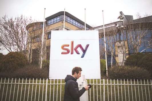 A pedestrian walks past Sky headquarters in Isleworth, London. The interest in Sky marks a reversal in sentiment for the London-based media company almost a year to the day since Fox announced a bid for full control of the company, whose shares were near their lowest point since 2012.