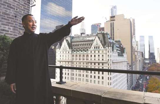 Billionaire Guo Wengui, who is seeking asylum in the United States after accusing officials in his native China of corruption, poses at his New York City apartment.