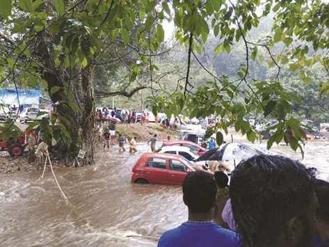Cars are stranded in floodwaters after heavy rains in Pampa, Pathanamthitta district, Kerala, yesterday.