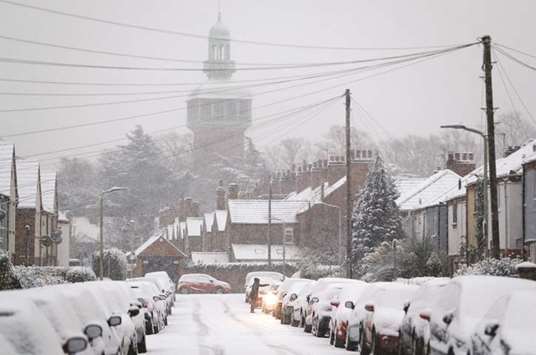 A resident clears snow from a car in Loughborough, yesterday.