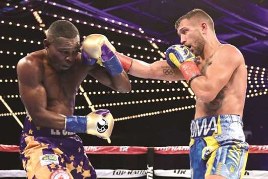 Vasiliy Lomachenko (right) punches Guillermo Rigondeaux during their Junior Lightweight bout at Madison Square Garden in New York City on Saturday. (AFP)