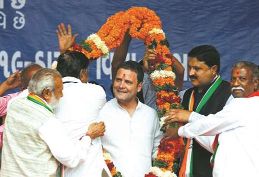 Congress vice president Rahul Gandhi is garlanded by supporters during an election campaign ahead of the second phase of Gujarat state Assembly elections, in Dakor, yesterday.