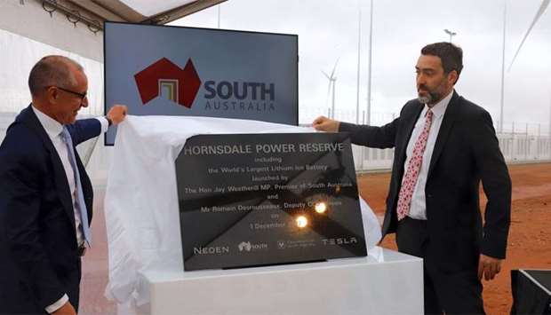 South Australian Premier, Jay Weatherill and Deputy CEO of Neoen, Romain Desrousseaux unveil a plaque during the official launch of the Hornsdale Power Reserve, featuring the world's largest lithium ion battery made by Tesla