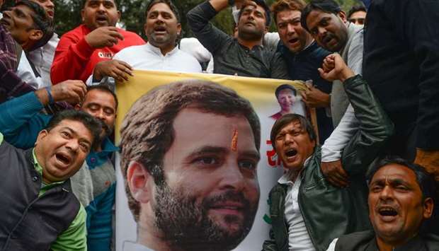 Indian supporters of the Congress Party shout slogans after the party named Rahul Gandhi president, outside Congress headquarters in New Delhi.  AFP