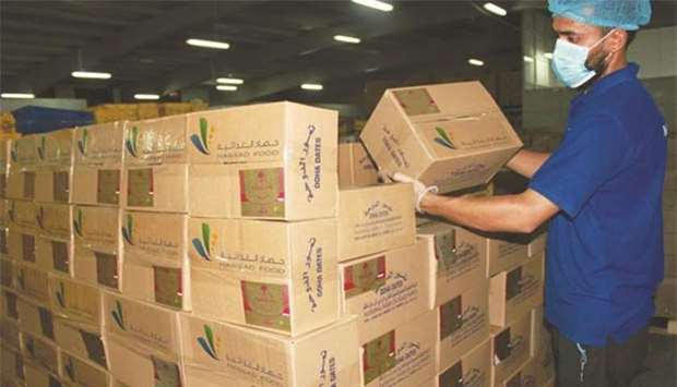 Hassad staff loading boxes of dates to be exported to India.- File picture