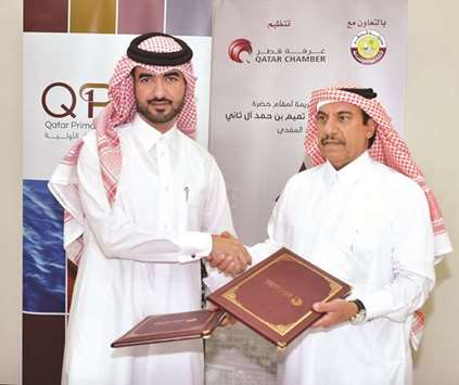 Qatar Chamber assistant director-general for Governmental and International Relations Ali Bu Sherbak al-Mansouri and QPMC head of Human Resources and Administrative Affairs Mohamed Abu Bakr al-Mahmoud shaking hands after signing the sponsorship agreement at the Chamberu2019s headquarters in Doha yesterday.