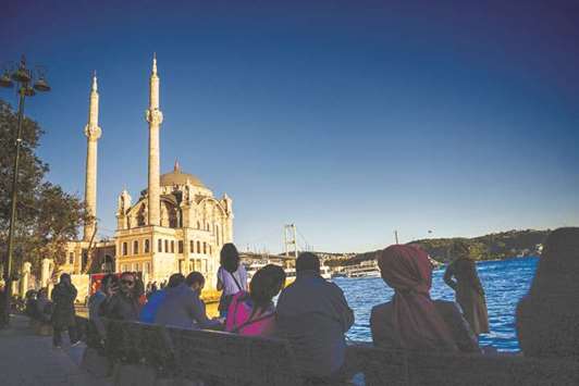 People sit on benches near the Bosphorus bridge in Istanbul (file). Turkeyu2019s gross domestic product expanded 11.1% in the three months to September 30 from a year earlier, the fastest pace in more than six years, according to official data released yesterday.
