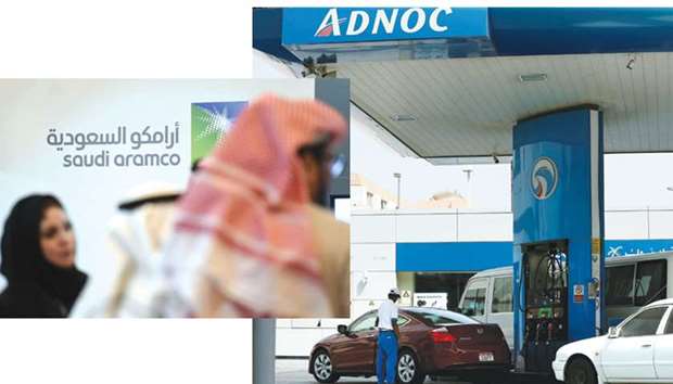 Saudi and foreign investors stand in front of the logo of state oil firm Aramco during a business event in the capital Riyadh. Right: A worker fills a car with fuel at an Adnoc petrol station in Abu Dhabi. Adnoc was earlier hoping the initial public offering would value its fuel retailing business at as much as $14bn. Nearly half a year later, Adnoc is settling for far less: $8.5bn.