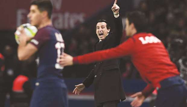 Paris Saint-Germain head coach Unai Emery (centre) gestures as he shouts instructions to his players from the touchline during the Ligue 1 match against Lille at the Parc des Princes stadium in Paris on Saturday. (AFP)