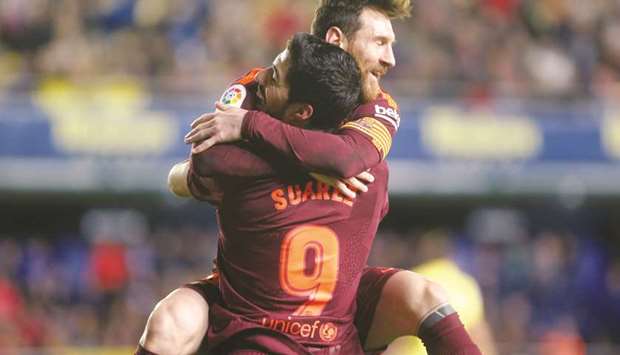 Barcelonau2019s Lionel Messi (right) celebrates scoring the teamu2019s second goal with teammate Luis Suarez during their La Liga match against Villareal in Vila-real, Spain, on Sunday. (Reuters)