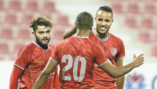 Al Duhailu2019s Youssef El Arabi (smiling) is congratulated by his teammates after scoring one of his six goals against Al Khor.