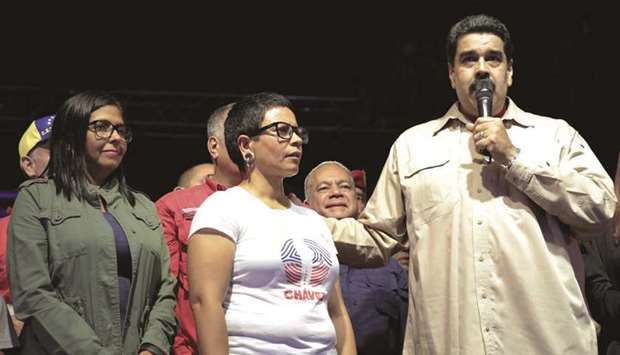 Venezuelau2019s President Nicolas Maduro speaks during an event with supporters, next to newly elected mayor of Libertador district Erika Farias (centre) and president of Venezuelau2019s National Constituent Assembly Delcy Rodriguez (left), in Caracas, Venezuela.