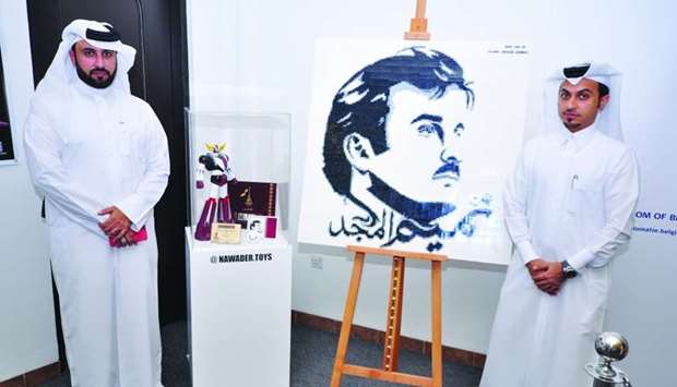 (From left) Faisal Mohamed al-Eissa and Abdulla Maqbool Khalfan with the u2018Grendizer Official Qatar Editionu2019 by Jungle and the Lego version of the popular 'Tamim Al Majd' portrait. PICTURES: Peter Alagos.