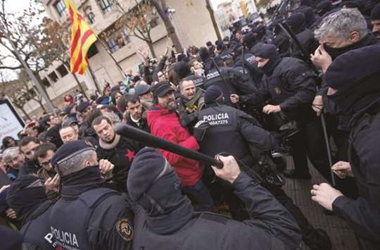 Mossos du2019Esquadra (Catalan regional police officers) scuffle with protesters in front of the Museum of Lleida after police entered the museum to carry out an order and return over 40 contested artworks to the Spanish region of Aragon following a protracted legal battle.