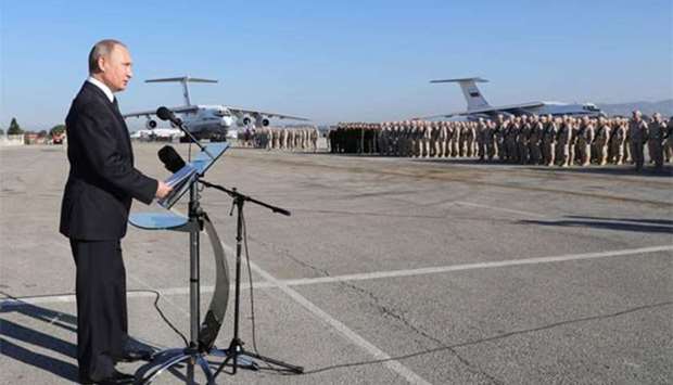 Russian President Vladimir Putin delivers a speech during his visit to the Russian air base in Hmeimim in the northwestern Syrian province of Latakia on Monday.