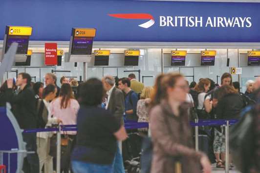 Passengers queue at check-in at the British Airways terminal, Terminal 5, at London Heathrow Airport in London. The Office for National Statistics said yesterday that the increase in inflation was driven by the cost of air fares and computer games.