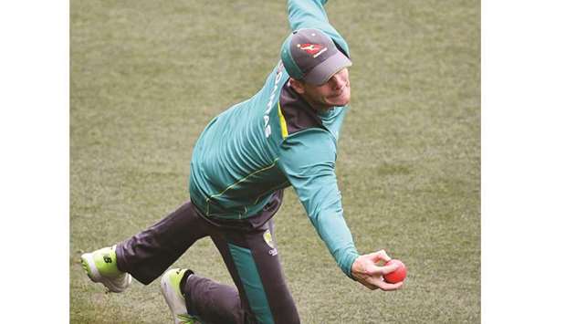 Australian cricket captain Steve Smith takes a catch during training in Adelaide yesterday.