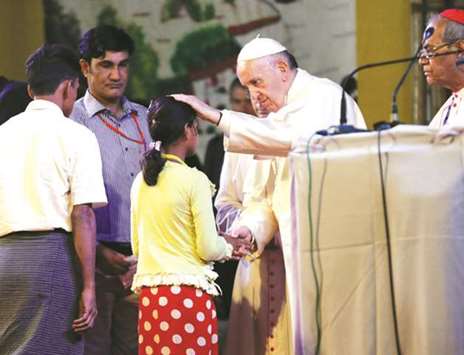 Pope Francis meets a group of Rohingya refugees during an inter-religious conference in Dhaka yesterday.