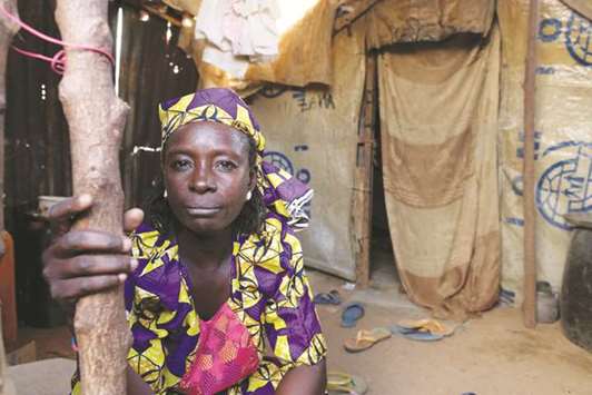 Zainab Bukar, an internally displaced person (IDP) living in Bama camp, Nigeria, poses for a picture in her shelter.